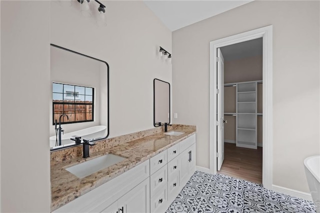 bathroom featuring hardwood / wood-style floors, a bathtub, and vanity