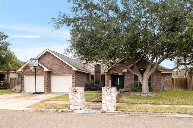 view of front of property featuring a garage and a front lawn