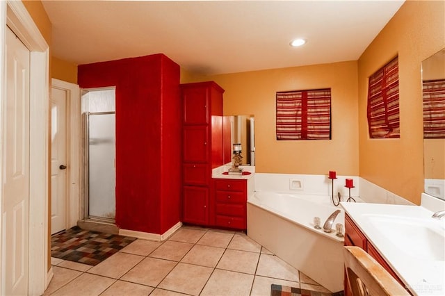 bathroom featuring vanity, shower with separate bathtub, and tile patterned floors