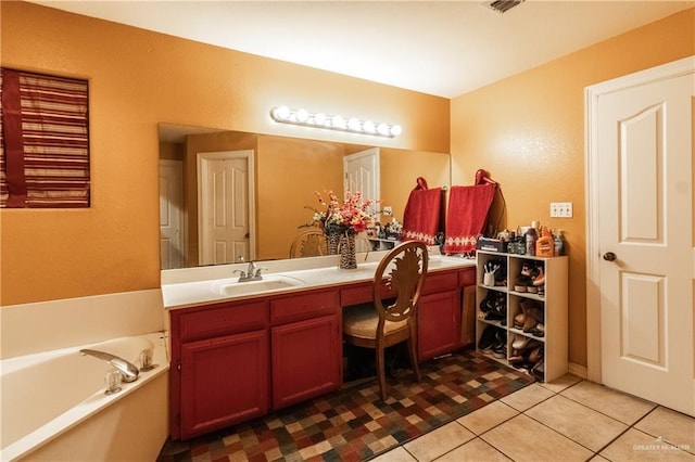 bathroom with vanity, a washtub, and tile patterned flooring