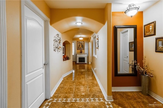 hall with dark tile patterned floors