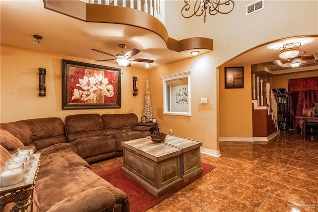 living room featuring dark tile patterned flooring and ceiling fan