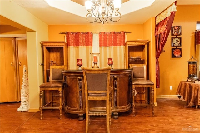 living area with hardwood / wood-style flooring and a notable chandelier