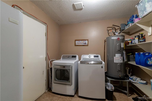 laundry area with separate washer and dryer, water heater, and a textured ceiling