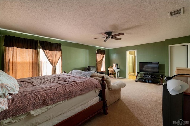 bedroom with carpet, ceiling fan, a textured ceiling, and connected bathroom