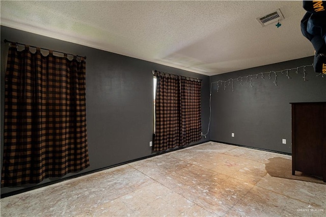 empty room featuring a textured ceiling