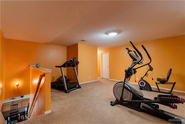 workout area with carpet and a textured ceiling