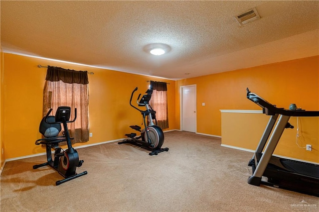 workout room with carpet flooring and a textured ceiling