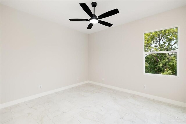 2705 E Solar Dr, Mission, TX 78501 - spare room featuring baseboards, marble finish floor, ceiling fan, and a wealth of natural light