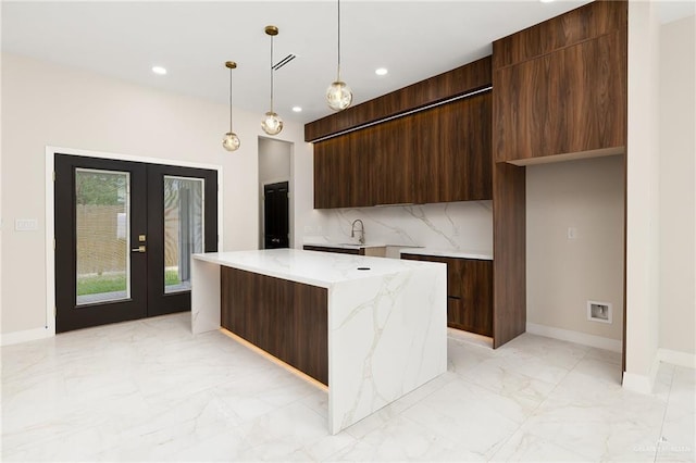 kitchen featuring a sink, french doors, marble finish floor, baseboards, and modern cabinets