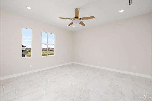 unfurnished room with baseboards, a ceiling fan, recessed lighting, and marble finish floor