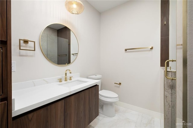 bathroom with vanity, baseboards, toilet, and marble finish floor