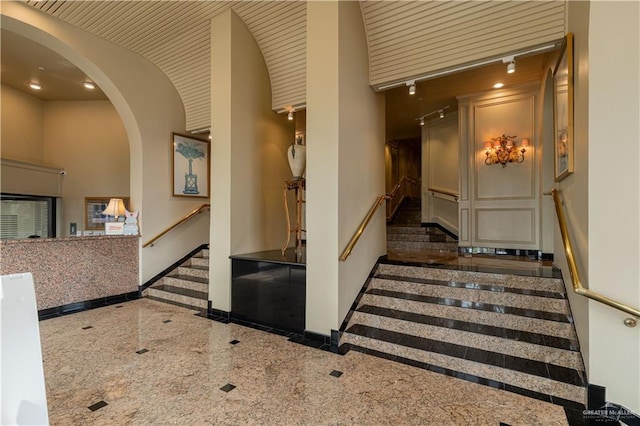 334 Padre Blvd Unit 801, South Padre Island, TX 78597 - stairway with inlaid floor details, granite floors, arched walkways, baseboards, and recessed lighting