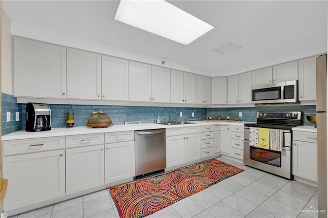 334 Padre Blvd Unit 801, South Padre Island, TX 78597 - kitchen featuring stainless steel appliances, a sink, light countertops, and backsplash