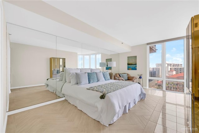 334 Padre Blvd Unit 801, South Padre Island, TX 78597 - bedroom with multiple windows, baseboards, and expansive windows
