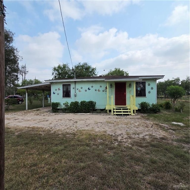 16073 S US Highway 281, San Benito, TX 78586 - view of front facade featuring a front yard, an attached carport, and entry steps