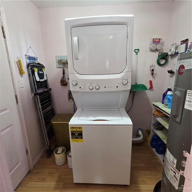 16073 S US Highway 281, San Benito, TX 78586 - washroom featuring stacked washer / drying machine, water heater, and light wood finished floors