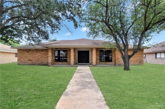 413 W Jonquil Ave, Mcallen, TX 78501 - ranch-style house with a front yard and brick siding