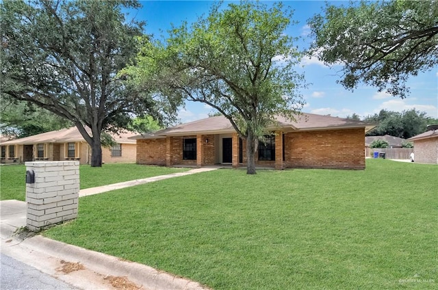 413 W Jonquil Ave, Mcallen, TX 78501 - ranch-style house with a front lawn and brick siding