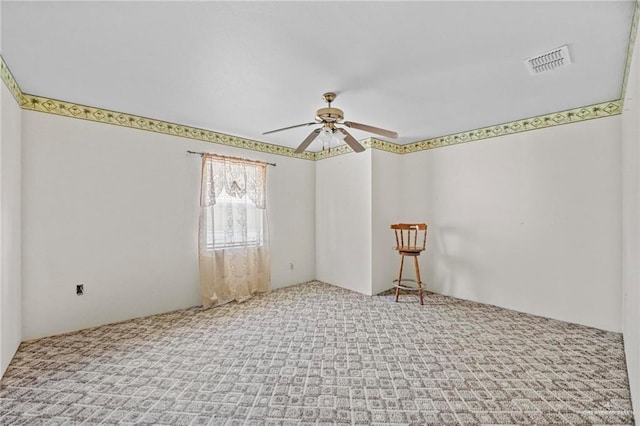 carpeted empty room featuring ceiling fan