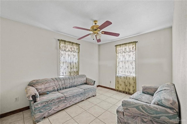 living room with ceiling fan and light tile patterned floors