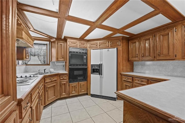 kitchen with backsplash, coffered ceiling, white appliances, sink, and light tile patterned floors