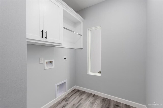 2023 Peace Dr, La Feria, TX 78559 - washroom with electric dryer hookup, light wood-type flooring, cabinet space, hookup for a washing machine, and baseboards