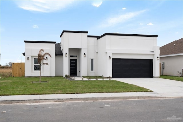 2023 Peace Dr, La Feria, TX 78559 - contemporary home featuring stucco siding, driveway, and an attached garage