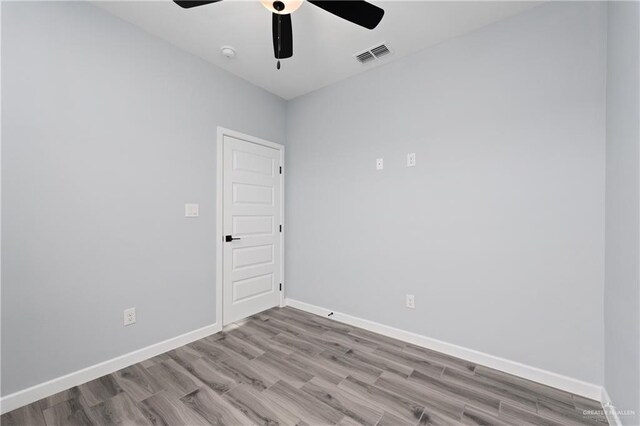 2023 Peace Dr, La Feria, TX 78559 - spare room featuring ceiling fan, wood finished floors, baseboards, and a smoke detector