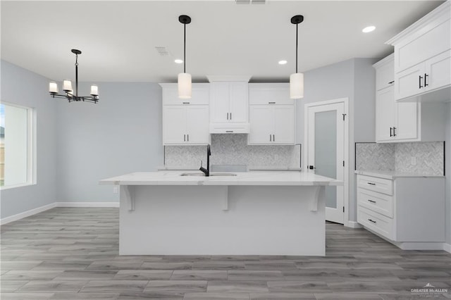 2023 Peace Dr, La Feria, TX 78559 - kitchen with a sink, backsplash, white cabinetry, recessed lighting, and baseboards