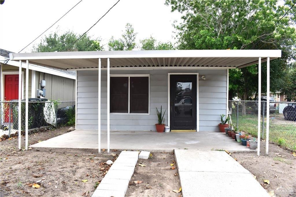 view of front of home featuring fence