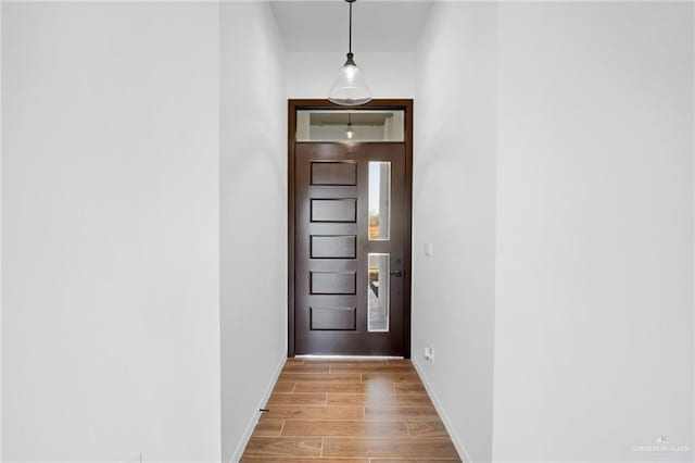 doorway to outside with light wood-type flooring