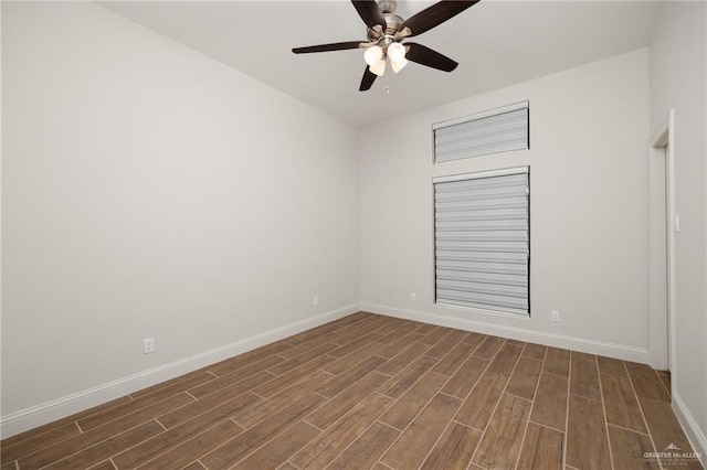 spare room with ceiling fan and dark hardwood / wood-style floors