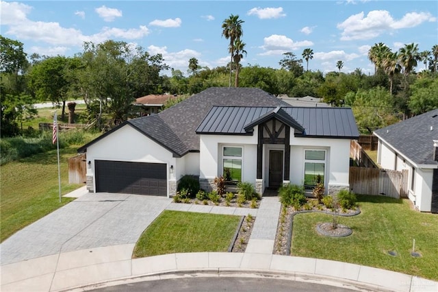 view of front of house featuring a garage and a front yard