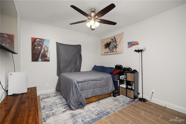 bedroom featuring ceiling fan and dark hardwood / wood-style flooring