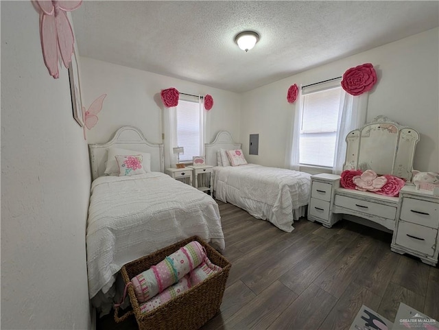 bedroom with dark wood-type flooring, multiple windows, and a textured ceiling