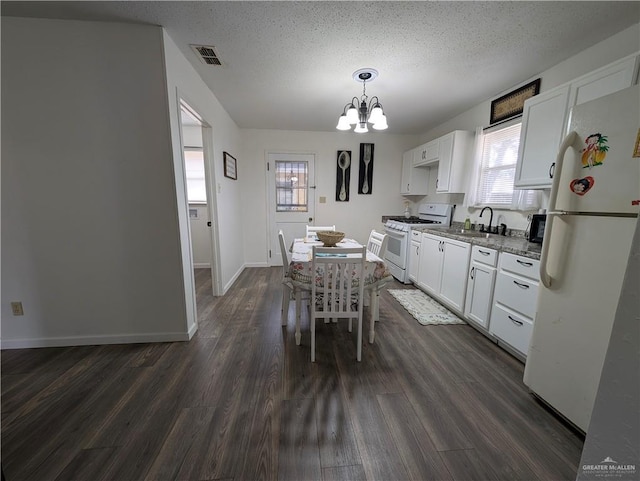 kitchen with white cabinetry, white appliances, sink, and light stone counters