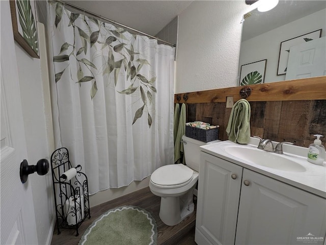 full bathroom with vanity, toilet, hardwood / wood-style floors, and shower / bath combo