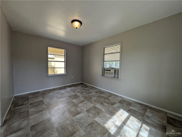 unfurnished room featuring plenty of natural light and cooling unit