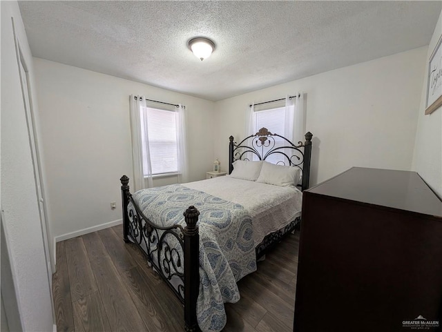 bedroom featuring dark hardwood / wood-style floors and a textured ceiling