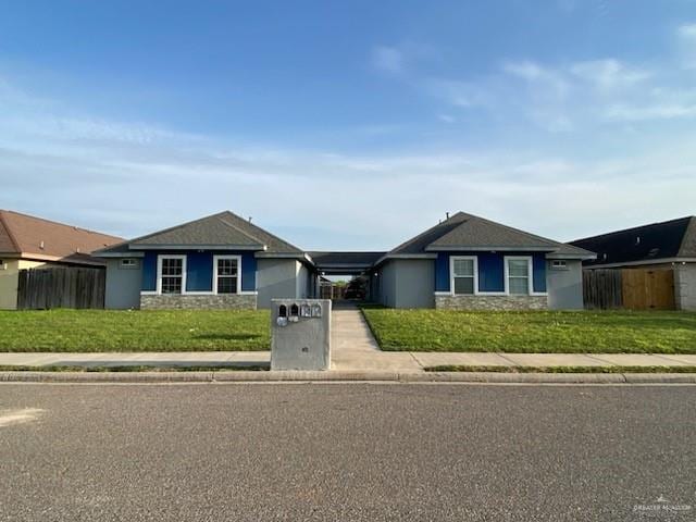 ranch-style home with a front lawn