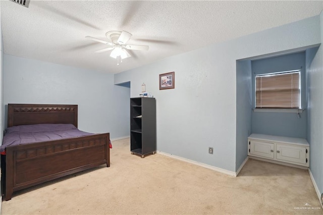 bedroom with a textured ceiling, light carpet, and baseboards