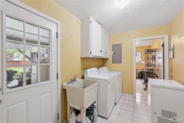 washroom featuring cabinet space, a sink, separate washer and dryer, light tile patterned floors, and electric panel