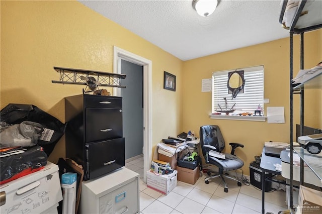 office area with a textured ceiling, a textured wall, and light tile patterned floors