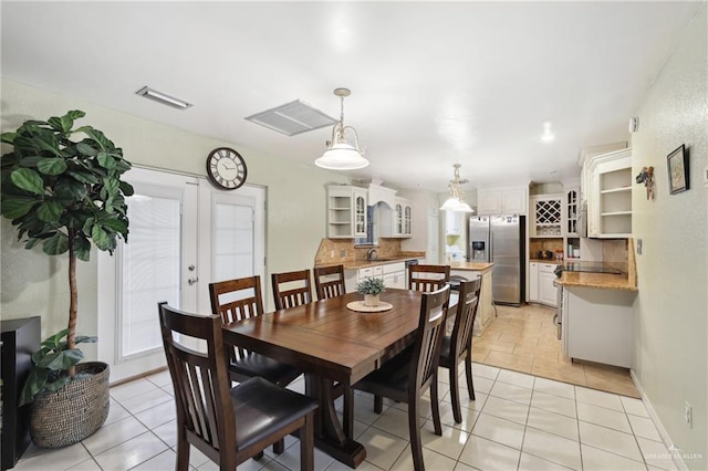 dining space with visible vents, baseboards, and light tile patterned floors