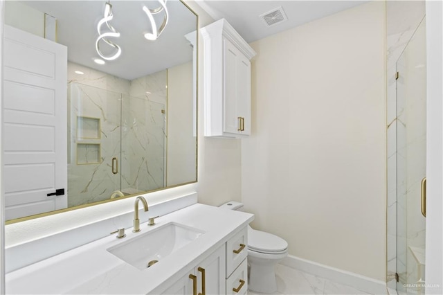 bathroom with vanity, a shower with shower door, and toilet