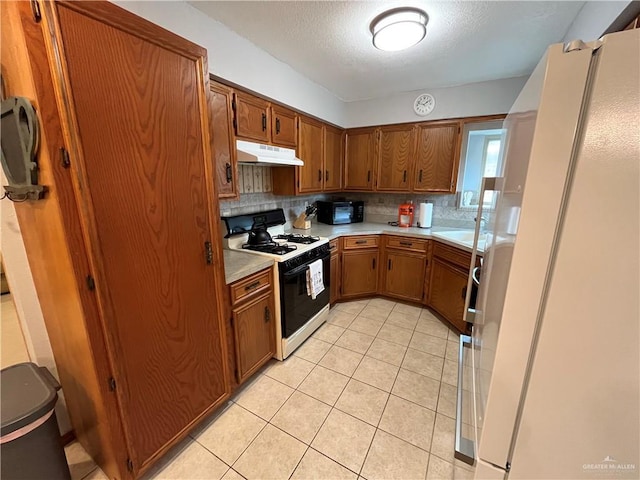 kitchen with white appliances, sink, decorative backsplash, a textured ceiling, and light tile patterned flooring