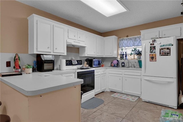 kitchen featuring kitchen peninsula, white cabinetry, sink, and white appliances