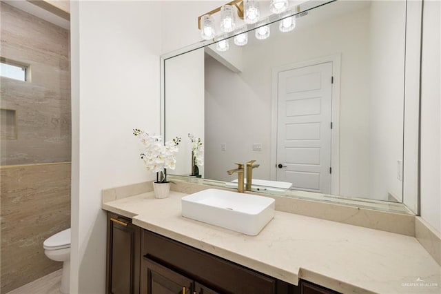 bathroom with vanity, toilet, and tile walls