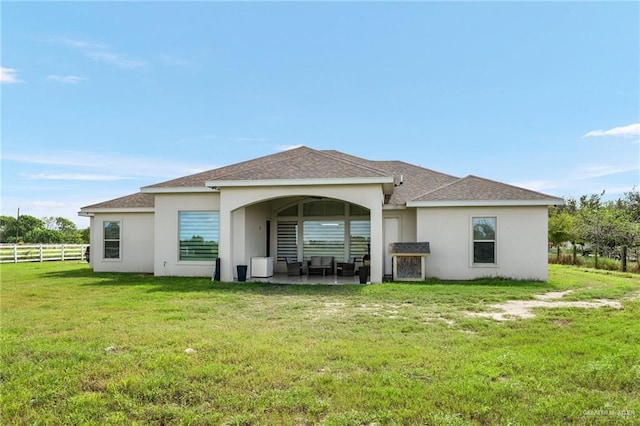 rear view of house featuring a lawn, a patio area, and outdoor lounge area